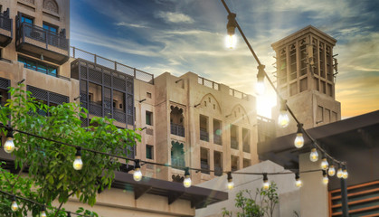 composited image design with festive lighting and sunset over classic Arabian styled architecture postmodern 