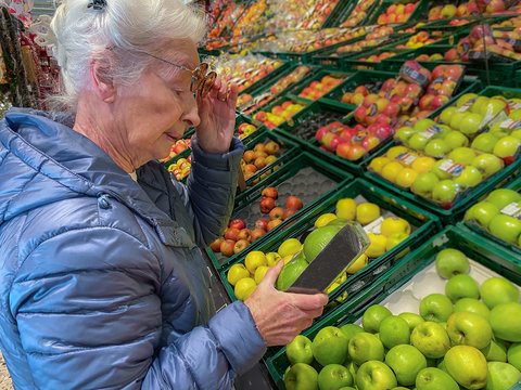 Senior Woman Buying Vegetables In The Supermarket