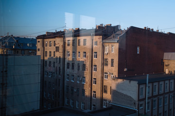 Reflection in the glass of typical houses in St. Petersburg, Russia.
