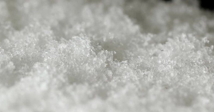 Snow accumulating on a windowpane, falling snowflakes closeup, 4k 60fps footage