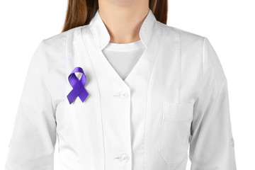 Doctor with purple ribbon as symbol of World Cancer Day on white background