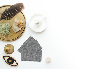 Tarot cards on a white background. Reading, feathers, crystals.