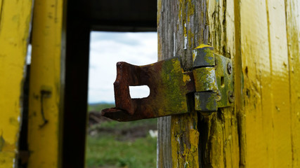 Wooden yellow fence with a latch
