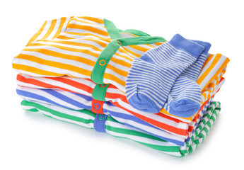 Stack of clean kid clothes on white background