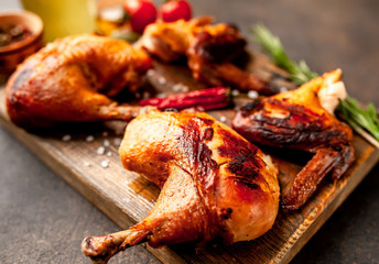 fried chicken wings and legs with spices, on a stone background, ready to eat