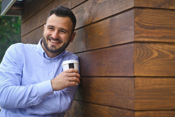 Portrait of a businessman, manager on a wooden wall background. A bearded sexy man in a shirt. Stock photos