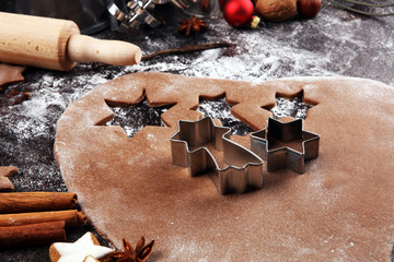 Baking christmas cookies. Typical cinnamon stars bakery with spices. xmas decoration on table