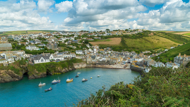Cityscape of Port Isaac, on the Atlantic coast in north Cornwall, England. The village centre dates from the 18th and 19th centuries. Turqoise water with fishing boats.