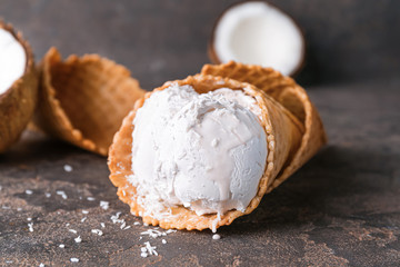 Sweet tasty coconut ice-cream on table