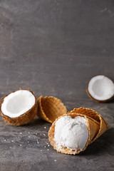 Sweet tasty coconut ice-cream on table
