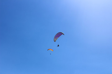 Paragliding in the blue sky on a sunny day.
