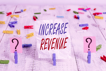 Handwriting text Increase Revenue. Conceptual photo increase in a company s is sales from one period to the next Scribbled and crumbling sheet with paper clips placed on the wooden table