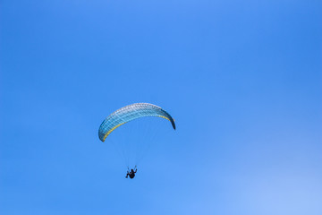 a paraglider flying in blue sky landscape in Indonesia