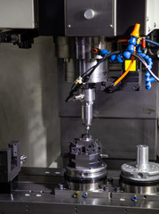 CNC milling machine cutting workpiece. Industrial metalworking machinery