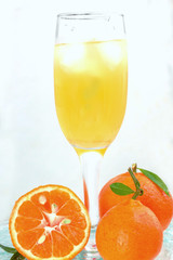 glass of champagne with cocktail, juice with ice tangerines with lmstochkami on glass light background