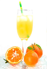 glass of champagne with cocktail, juice with ice tangerines with lmstochkami green tube on glass light background