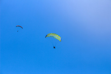 a paraglider flying in blue sky landscape in Indonesia