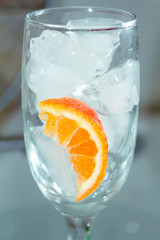champagne glass with cocktail oranges with ice close up