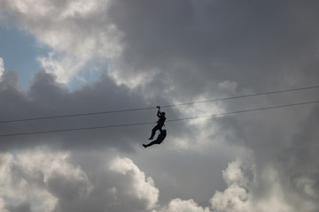 People having fun using a zip line 