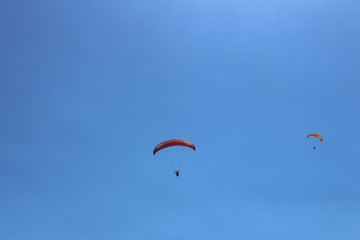 a paraglider flying in blue sky landscape in Indonesia