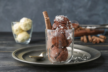 Glass with tasty chocolate ice-cream on table
