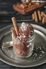 Glass with tasty chocolate ice-cream on table