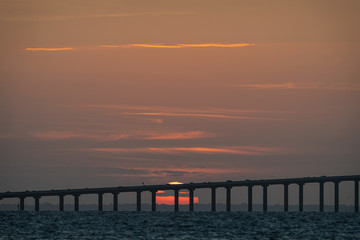 Fototapeta na wymiar Sun rising over the Sunshine Skyway Bridge, St. Petersburg, Florida