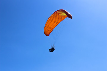 a paraglider flying in blue sky landscape in Indonesia