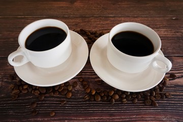 cup of coffee and beans on wooden table