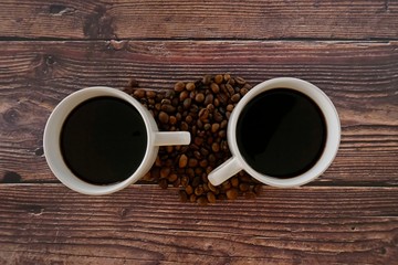 cup of coffee and beans on wooden table