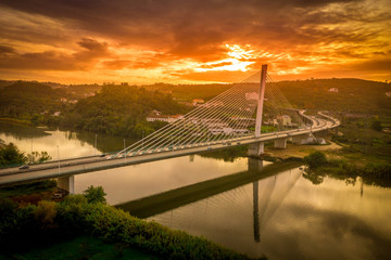 Aerial view of the Santa Isabel Queen modern steel cable bridge in Coimbra during sunset