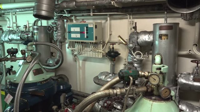 camera shows oil separator for cleaning liquids with centrifugal force and meters at pipelines in tanker machinery room