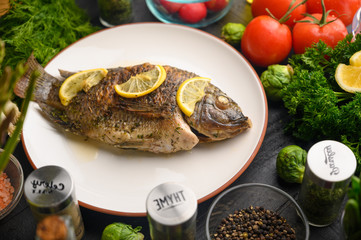 Grilled fish with fresh vegetables, on a wooden black background. I also eat healthy food. Seafood