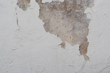 White walls with cracks and peeling paint.