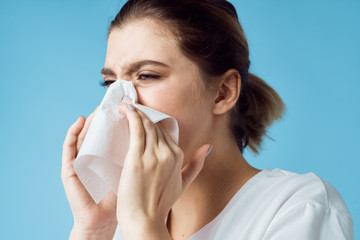 young woman blowing her nose