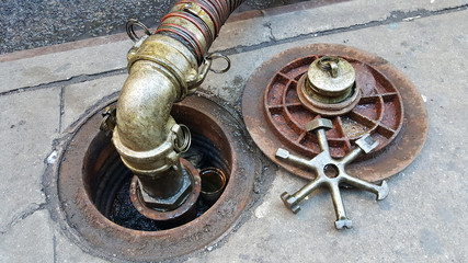 piped in heating fuel oil delivery service, city sidewalk and lug wrench