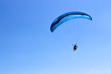 Paragliding in the blue sky on a sunny day.