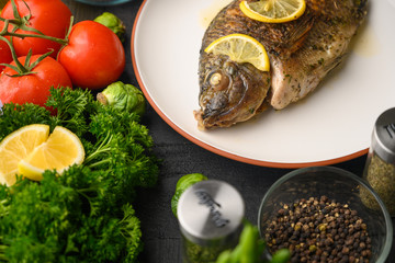 Ready cooked fish on a background with vegetables. Cooking recipes, restaurant business, culinary recipes