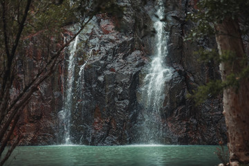 Fototapeta premium Waterfall scene with crisp blue water, Cedar Creek Falls, Queensland Australia