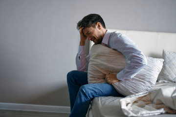 man sitting on sofa at home