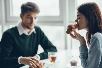 young couple having breakfast in cafe