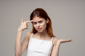 portrait of young woman pointing at copyspace