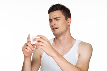 young man applying cream on his face
