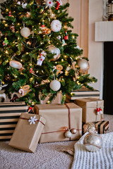 Decorated gifts under Christmas tree at home 