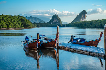 Obraz premium Boat and Twin mountains in the morning. Landmarks of Krabi Province, Thailand.