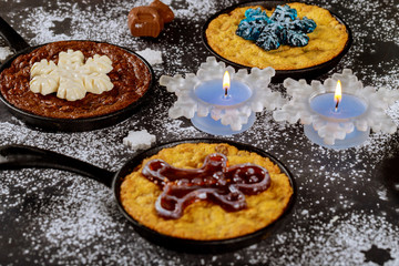 Burning candles on the dinning table with food, decorated for Christmas night or New Year.