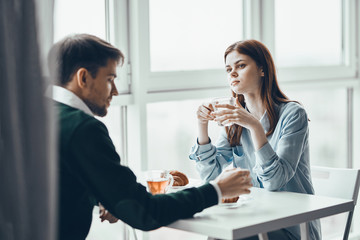 young couple having breakfast in the kitchen