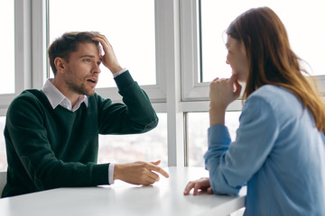 man and woman shaking hands in office