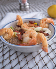 Shrimp and vegetables on stone ground grits in bowl