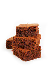 Pieces of traditional Belgian chocolate biscuit brownie lies pyramid on a white background. Vertical  photo with.